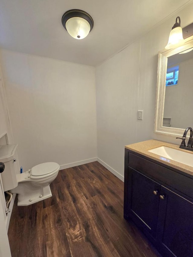 9829 W Lincoln Ave, West Allis, WI 53227 - half bath featuring toilet, wood finished floors, vanity, and baseboards