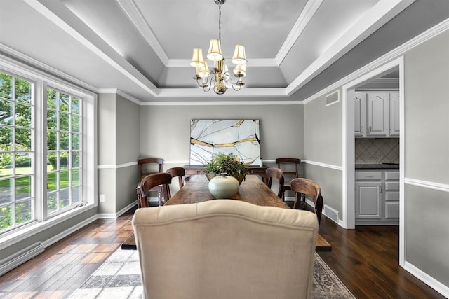 3948 Trempealeau Trl, Verona, WI 53593 - dining space with a raised ceiling, a chandelier, hardwood / wood-style floors, ornamental molding, and baseboards