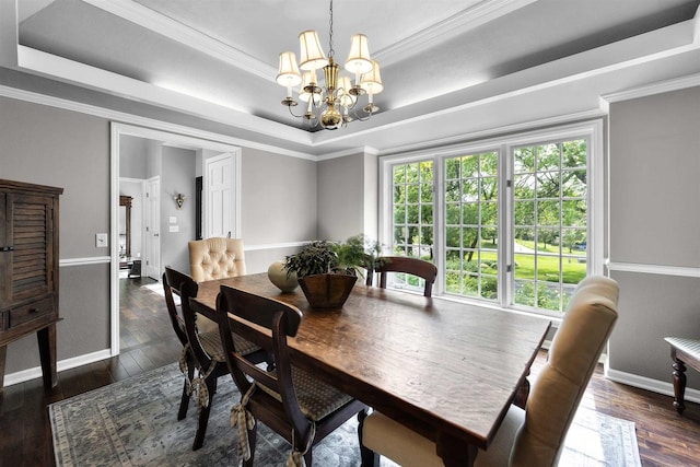 3948 Trempealeau Trl, Verona, WI 53593 - dining space featuring a tray ceiling, a chandelier, dark wood finished floors, baseboards, and crown molding
