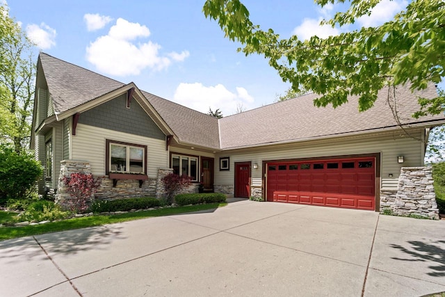 100 Accipiter Ct, Burlington, WI 53105 - craftsman-style house with stone siding, concrete driveway, a garage, and roof with shingles