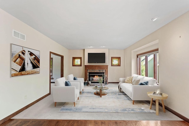 100 Accipiter Ct, Burlington, WI 53105 - living room featuring baseboards, a brick fireplace, and wood finished floors