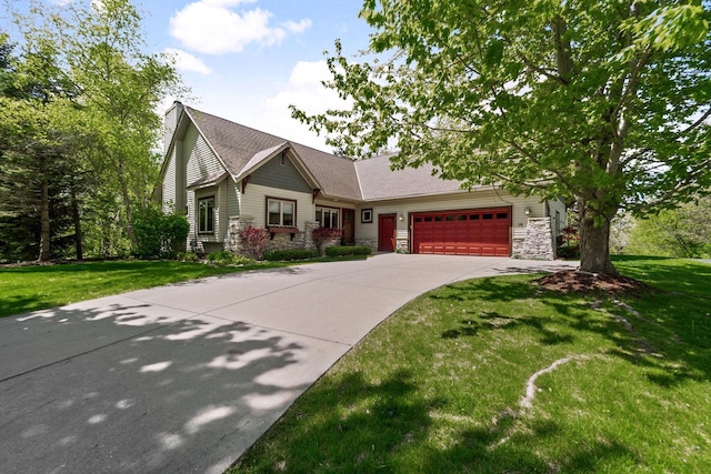 100 Accipiter Ct, Burlington, WI 53105 - craftsman inspired home featuring an attached garage, driveway, stone siding, and a front yard