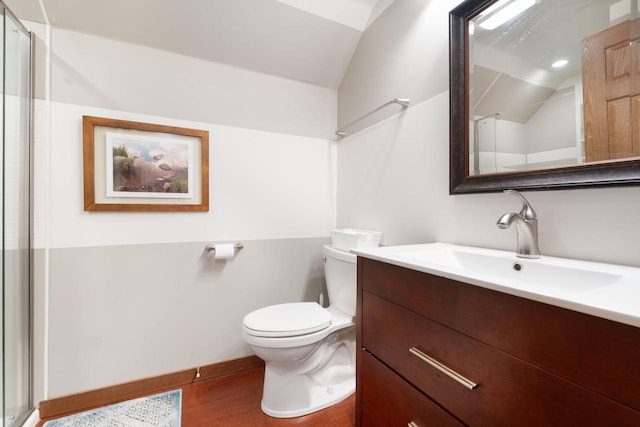 100 Accipiter Ct, Burlington, WI 53105 - bathroom featuring vaulted ceiling, vanity, toilet, an enclosed shower, and wood finished floors