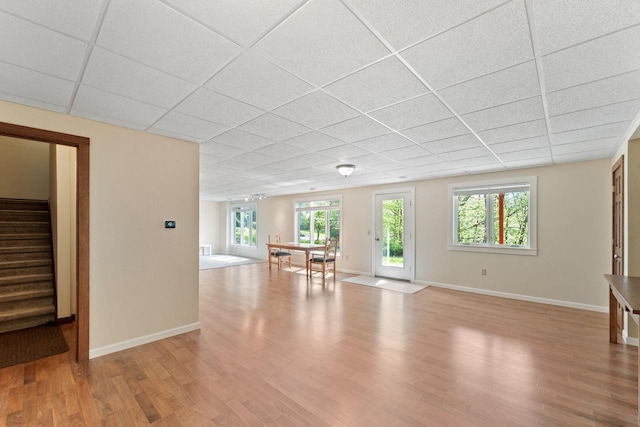 100 Accipiter Ct, Burlington, WI 53105 - spare room with a paneled ceiling, light wood-type flooring, stairway, and baseboards