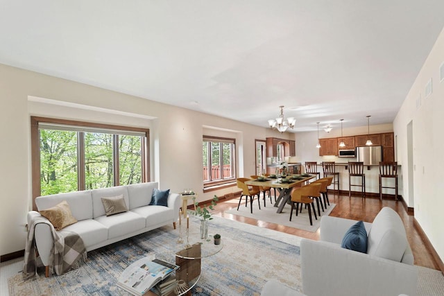 100 Accipiter Ct, Burlington, WI 53105 - living area featuring a chandelier, baseboards, and wood finished floors