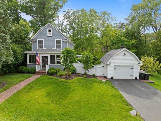 170 N Lakeshore Dr, Fontana, WI 53125 - colonial inspired home featuring a detached garage, a gambrel roof, an outdoor structure, driveway, and a chimney