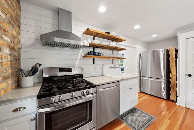 170 N Lakeshore Dr, Fontana, WI 53125 - kitchen featuring stainless steel appliances, wall chimney range hood, a sink, light countertops, and recessed lighting