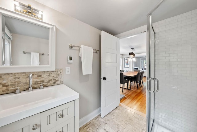 170 N Lakeshore Dr, Fontana, WI 53125 - full bathroom with vanity, backsplash, a shower stall, and baseboards