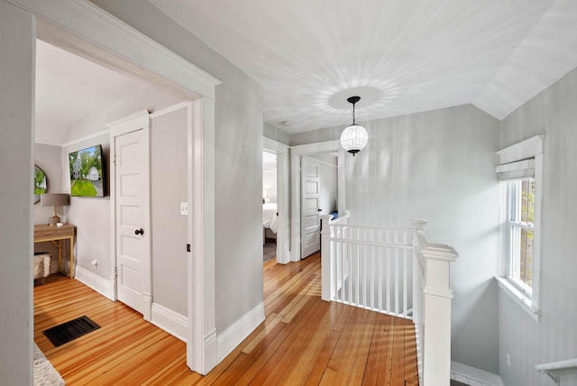 170 N Lakeshore Dr, Fontana, WI 53125 - hall with an upstairs landing, light wood-style flooring, vaulted ceiling, and baseboards