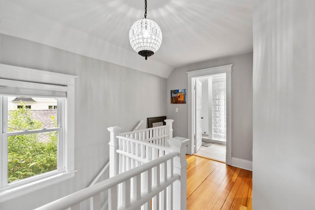 170 N Lakeshore Dr, Fontana, WI 53125 - hall featuring an upstairs landing, a chandelier, light wood-style flooring, baseboards, and vaulted ceiling