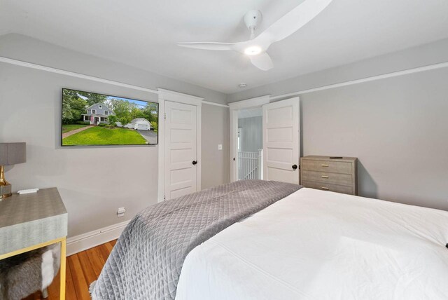 170 N Lakeshore Dr, Fontana, WI 53125 - bedroom with wood finished floors, a ceiling fan, and baseboards