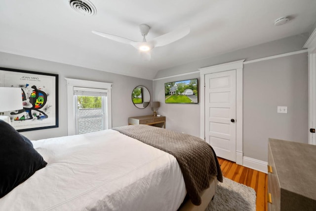 170 N Lakeshore Dr, Fontana, WI 53125 - bedroom with wood finished floors, baseboards, a ceiling fan, and lofted ceiling