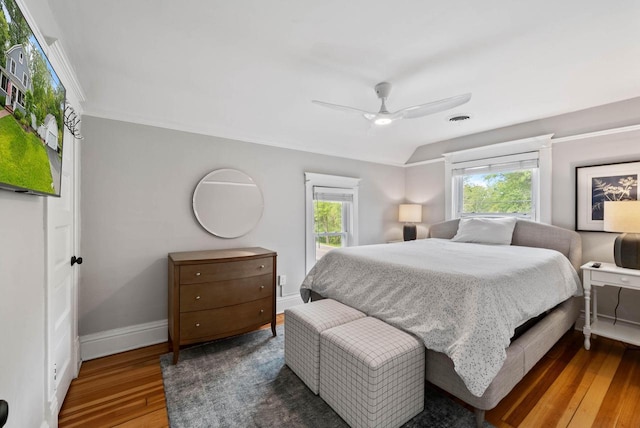 170 N Lakeshore Dr, Fontana, WI 53125 - bedroom with multiple windows, hardwood / wood-style flooring, baseboards, and a ceiling fan