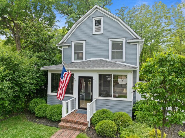 170 N Lakeshore Dr, Fontana, WI 53125 - view of front of house with a sunroom and a shingled roof