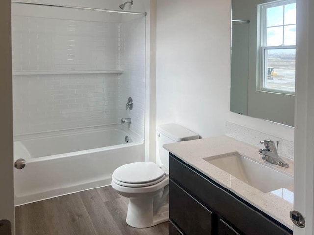 5010 Linden Rd, Mount Pleasant, WI 53403 - bathroom with toilet, vanity,  shower combination, and wood finished floors