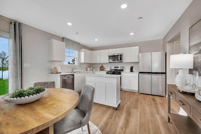 5010 Linden Rd, Mount Pleasant, WI 53403 - kitchen with stainless steel appliances, plenty of natural light, a sink, white cabinets, and recessed lighting