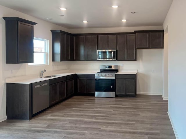 5010 Linden Rd, Mount Pleasant, WI 53403 - kitchen with appliances with stainless steel finishes, dark brown cabinets, baseboards, and recessed lighting