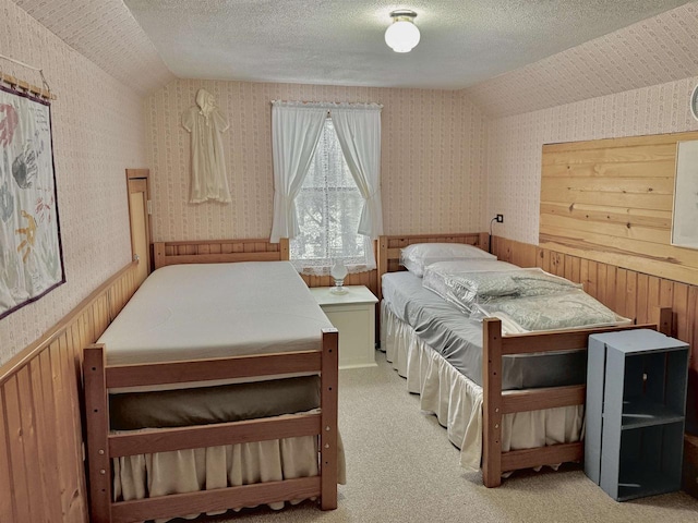 1657 N Elm Rd, Junction City, WI 54443 - carpeted bedroom featuring wallpapered walls, vaulted ceiling, a wainscoted wall, and wooden walls