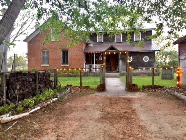 1657 N Elm Rd, Junction City, WI 54443 - view of front of property with a porch, a fenced front yard, and brick siding