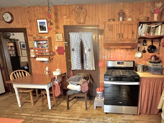 1657 N Elm Rd, Junction City, WI 54443 - kitchen featuring stainless steel gas stove, wooden walls, and light wood-type flooring