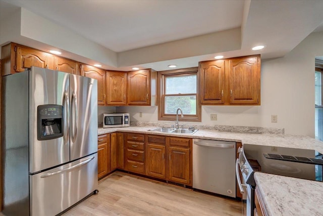 1230 N Westfield Rd, Madison, WI 53717 - kitchen with appliances with stainless steel finishes, brown cabinets, light wood-style flooring, light countertops, and recessed lighting