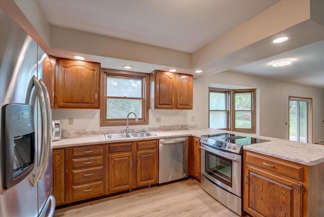 1230 N Westfield Rd, Madison, WI 53717 - kitchen with appliances with stainless steel finishes, a peninsula, brown cabinets, and recessed lighting
