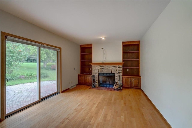 1230 N Westfield Rd, Madison, WI 53717 - unfurnished living room with light wood-style flooring, a brick fireplace, and built in features
