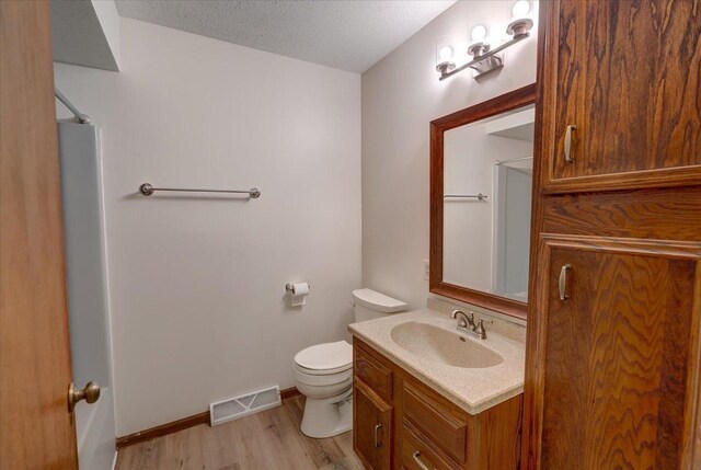 1230 N Westfield Rd, Madison, WI 53717 - bathroom featuring vanity, wood finished floors, a shower, and a textured ceiling