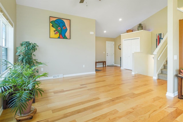 951 Lavender Way, Deforest, WI 53532 - unfurnished living room with light wood finished floors, stairway, a ceiling fan, vaulted ceiling, and baseboards