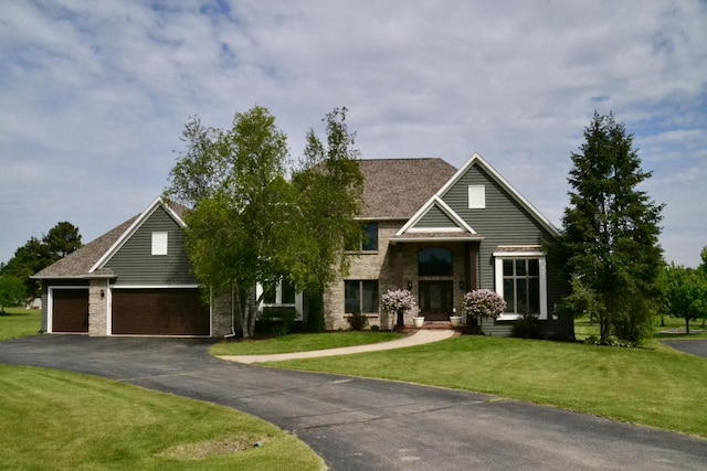 W4745 Briar Dr, Elkhorn, WI 53121 - traditional home featuring a garage, a front lawn, and driveway