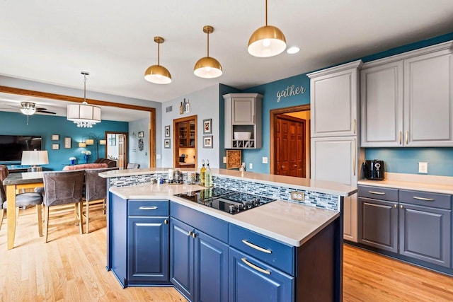 W4745 Briar Dr, Elkhorn, WI 53121 - kitchen featuring black electric cooktop, light wood-style floors, light countertops, and open floor plan