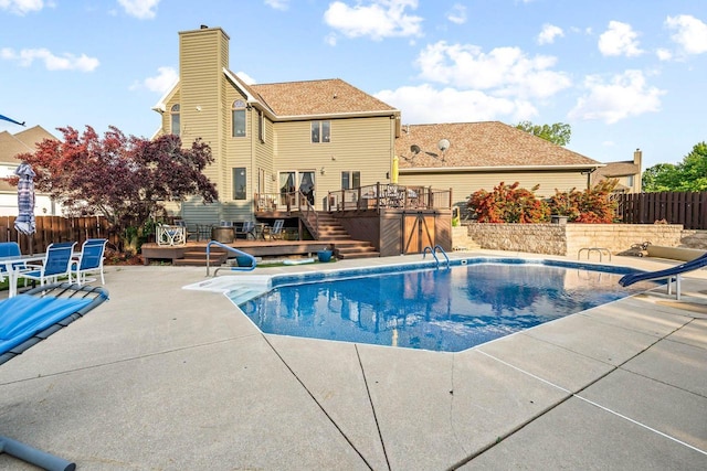 W4745 Briar Dr, Elkhorn, WI 53121 - view of pool with a wooden deck, a patio area, a water slide, and a fenced backyard