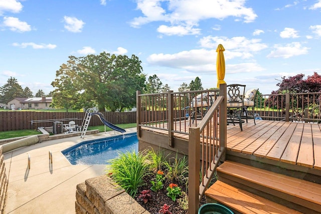 W4745 Briar Dr, Elkhorn, WI 53121 - view of pool featuring a water slide, a fenced backyard, a wooden deck, and a patio