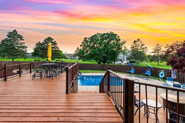 W4745 Briar Dr, Elkhorn, WI 53121 - pool at dusk with a fenced backyard, a wooden deck, and outdoor dining space