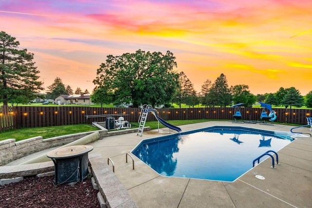 W4745 Briar Dr, Elkhorn, WI 53121 - pool at dusk featuring a water slide and a patio area