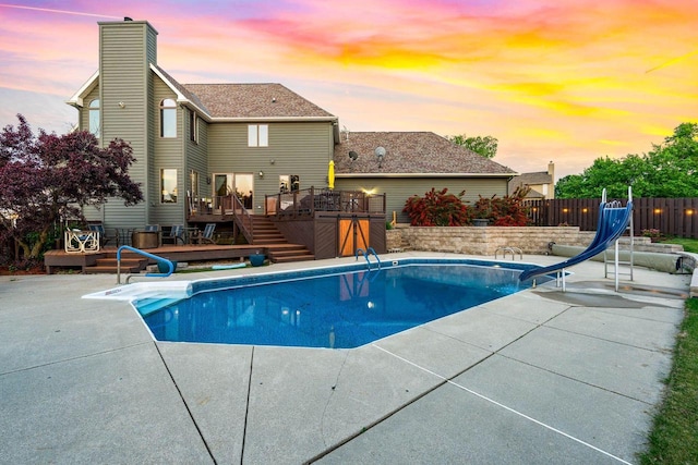 W4745 Briar Dr, Elkhorn, WI 53121 - pool at dusk with a water slide, a deck, and a patio