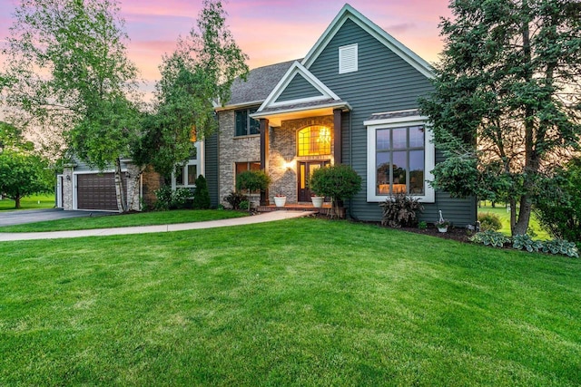 W4745 Briar Dr, Elkhorn, WI 53121 - traditional-style house with a garage, a lawn, driveway, and brick siding