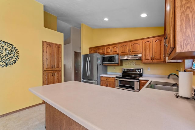 136 Yacoub Ln, Fond Du Lac, WI 54935 - kitchen featuring stainless steel appliances, under cabinet range hood, a peninsula, light countertops, and high vaulted ceiling