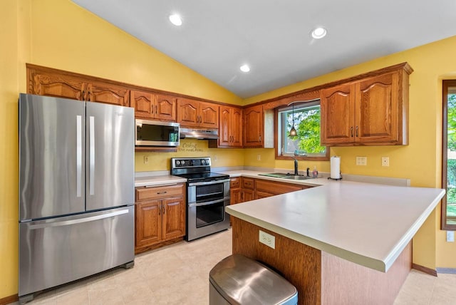 136 Yacoub Ln, Fond Du Lac, WI 54935 - kitchen with stainless steel appliances, under cabinet range hood, a peninsula, brown cabinets, and a sink