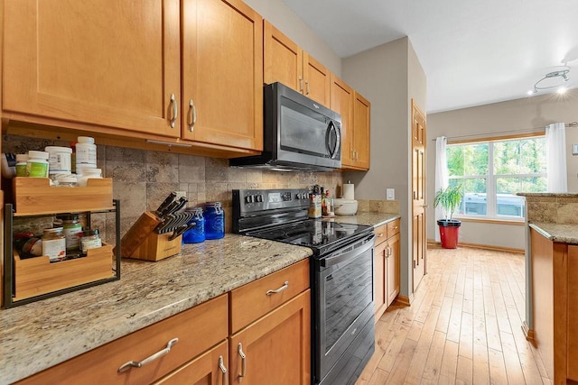 691 N River St Unit 1, Merrimac, WI 53561 - kitchen featuring black microwave, electric stove, tasteful backsplash, and light stone counters