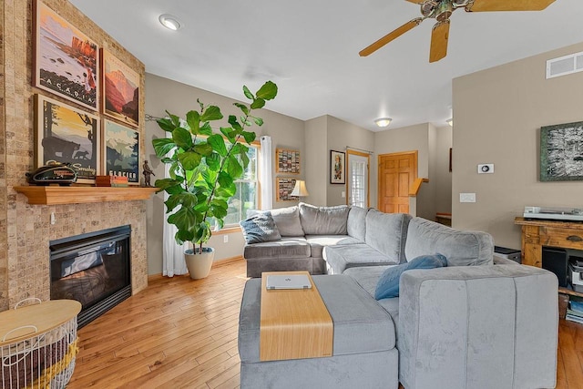 691 N River St Unit 1, Merrimac, WI 53561 - living area with ceiling fan, hardwood / wood-style floors, a tile fireplace, and baseboards