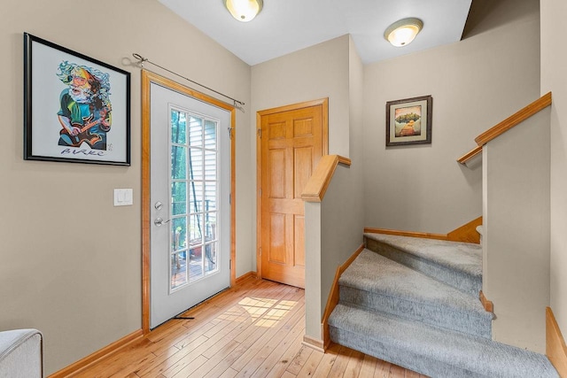 691 N River St Unit 1, Merrimac, WI 53561 - entryway with light wood-type flooring, stairs, and baseboards