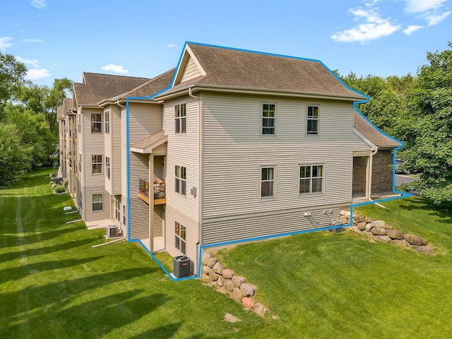 691 N River St Unit 1, Merrimac, WI 53561 - view of property exterior featuring cooling unit, a yard, and roof with shingles
