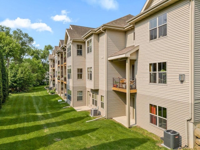 691 N River St Unit 1, Merrimac, WI 53561 - rear view of property with central air condition unit, a yard, and a shingled roof