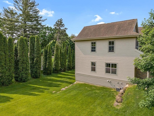 691 N River St Unit 1, Merrimac, WI 53561 - view of side of home with a lawn and a shingled roof