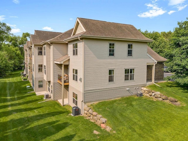 691 N River St Unit 1, Merrimac, WI 53561 - rear view of property with cooling unit, a yard, and roof with shingles