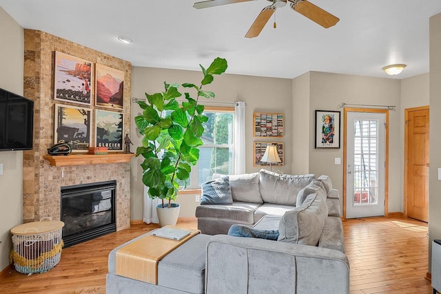 691 N River St Unit 1, Merrimac, WI 53561 - living area featuring wood finished floors, a ceiling fan, baseboards, and a tile fireplace