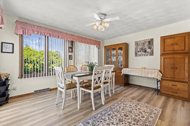 636 Westbury Ln Unit 12, Delavan, WI 53115 - dining room featuring light wood-style flooring, baseboards, and ceiling fan