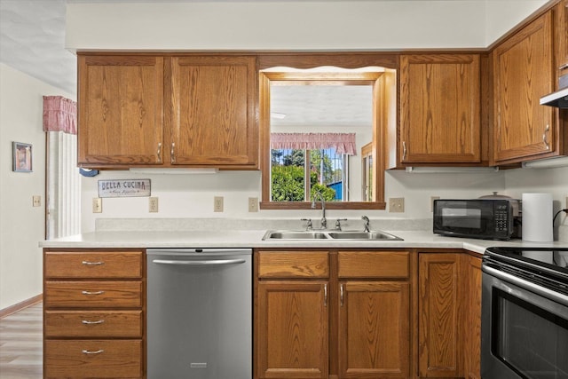 636 Westbury Ln Unit 12, Delavan, WI 53115 - kitchen with stainless steel appliances, a sink, light countertops, and brown cabinets