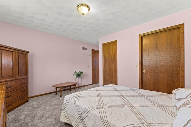 636 Westbury Ln Unit 12, Delavan, WI 53115 - bedroom featuring light colored carpet and baseboards